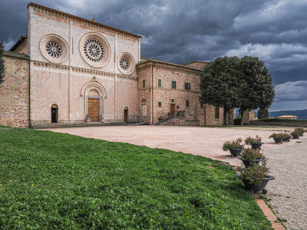 Assisi, Perugia, Umbria, Italy: The facade of St. Peter's Basilica is in Romanesque style with three large rose windows.