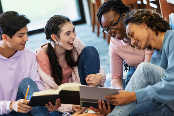 istock Four high school students studying together in library 2152265386