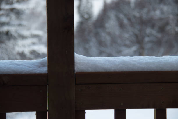 istock snow on a wooden railing 2152268019