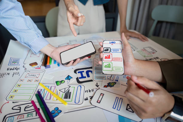istock Brainstorm planning creative asian teamwork, Group of mobile phone app developer team meeting for share ideas about screen prototype layout for smartphone, ui, ux startup small business 2152268241