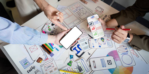 istock Brainstorm planning creative asian teamwork, Group of mobile phone app developer team meeting for share ideas about screen prototype layout for smartphone, ui, ux startup small business 2152268267