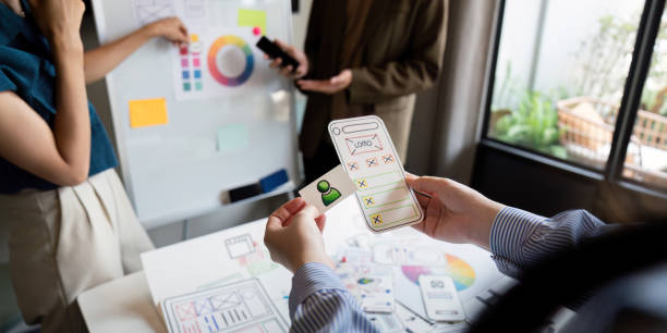 istock Brainstorm team of creative web graphic designer planning. Creative designers present ux ui to team. Designers team working meeting in office 2152268271