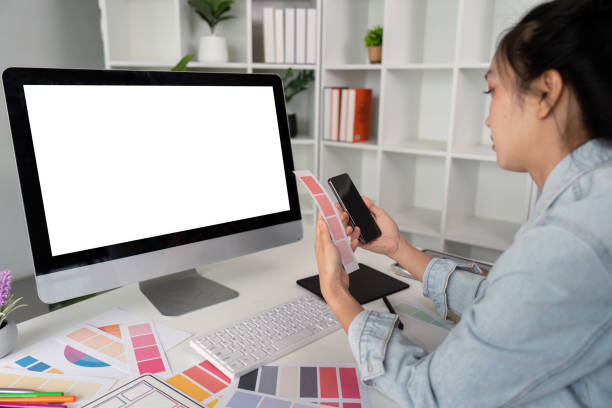 istock Woman sit at workplace desk with digital graphic staring at computer white mock up screen working professional program concept 2152269441
