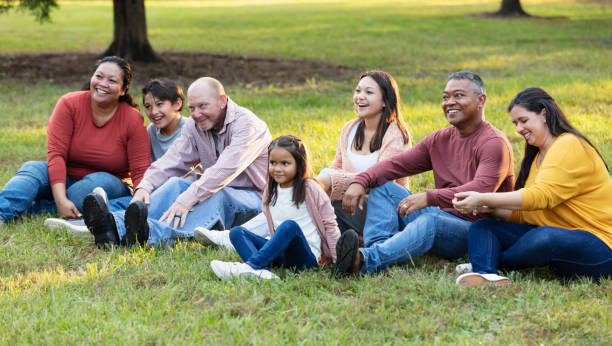 istock Multiracial extended family sitting on grass together 2152269711