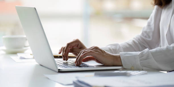 Professional businesswoman working at her office on laptop, work process concept