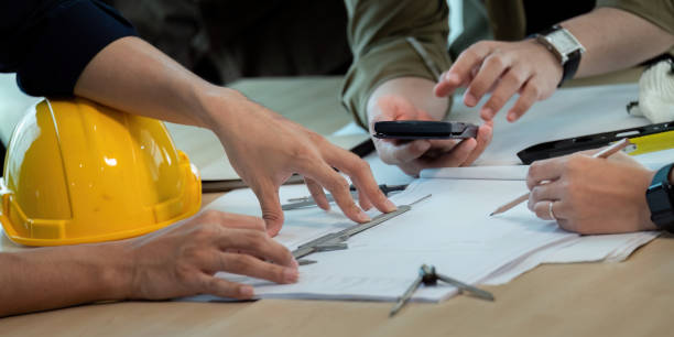 istock Construction and structure of engineer or architect meeting for project working with partner and tools on model building and blueprint in working site 2152272174