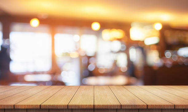 istock Empty wooden table top with lights bokeh on blur restaurant background. 2152275215