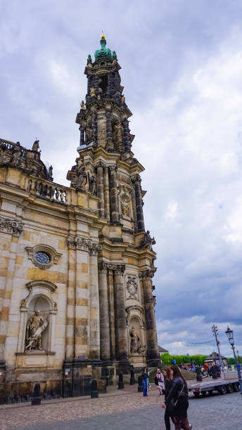 Dresden, Germany - April 18, 2024: People going near Cathedral Katholische Hofkirche on Theaterplatz square.