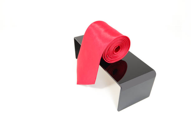 istock Plain fabric polyester necktie rolled on display stand with white background close-up view single object concept no people 2152278193