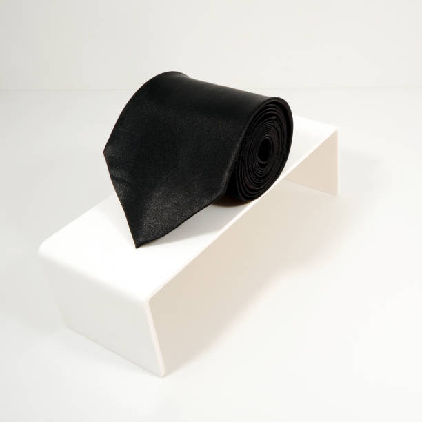 istock Plain fabric polyester necktie rolled on display stand with white background close-up view single object 2152279144
