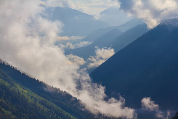 mountain chain silhouette in mist and dense clouds