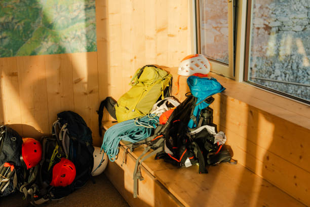 climbing gear on bench in cabin illuminated by sunset light