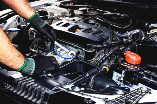 istock Car mechanic using a wrench to repair car engine 2152282228