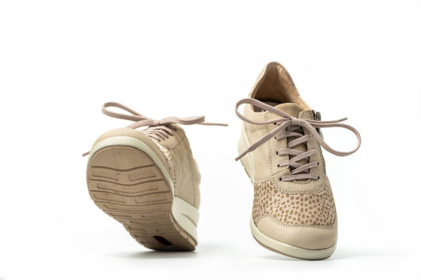 istock Beige female sneakers on white 2152284075