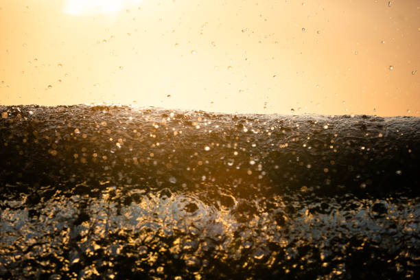 Small spray droplets landing on the crest of a breaking wave