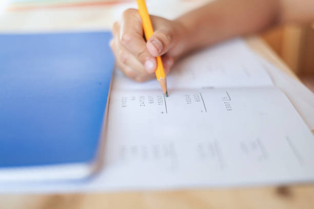 istock Close-Up Of A 9 Year Old Boy Using A Pencil Doing Math Exercises. 2152284525