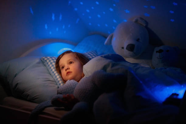 istock Little girl reading a book in bed 2152284811