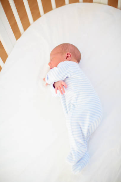 istock Little baby on white bed 2152285207