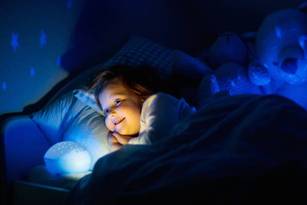 istock Little girl reading a book in bed 2152286752
