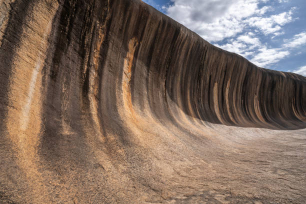 istock Wave Rock - Natural rock scuplped by time into a colossal ochre wave 2152286928