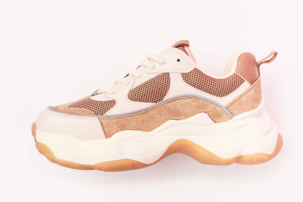 istock Stylish sneakers on a pink background, close-up side view. 2152287060