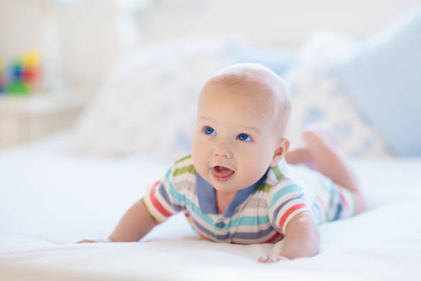 istock Little baby on white bed 2152287806