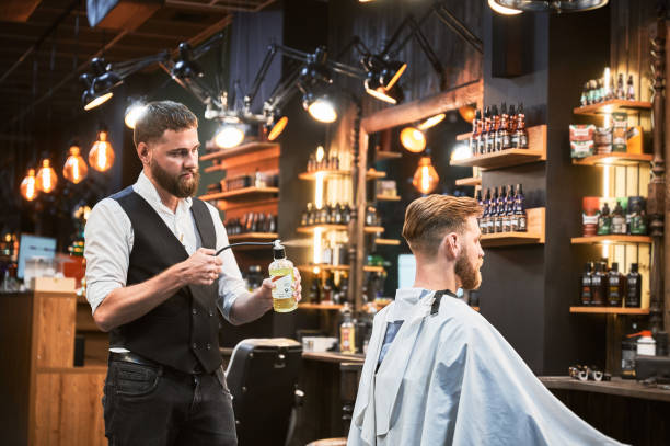 istock Professional barber spraying aftershave lotion on client's nape. 2152288647