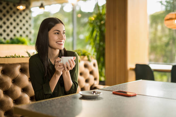 istock Happy woman enjoying coffee time at cafe. 2152293509