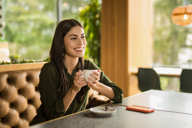 istock Happy woman enjoying a coffee break at cafe. 2152293525