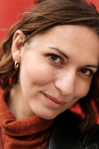 istock Head-shot of authentic woman on red background. 2152295583