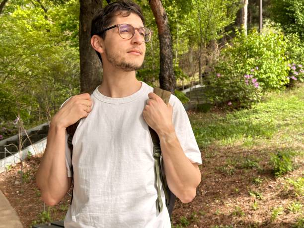 istock Travel guy with a backpack looking into the distance. Free space for text 2152299103