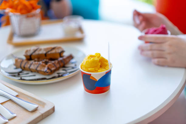 istock Ice cream cup on table amoung happy people blur background 2152301789