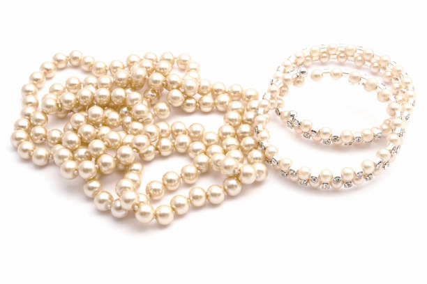 istock Bracelet and pearl necklace isolated on white 2152301802