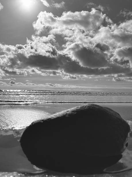 istock A single large boulder rock on the beach with the North Sea in the background 2152302020