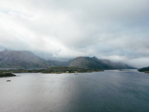 Drone view of Northern Norway, mountains and fjord on a cloudy day.