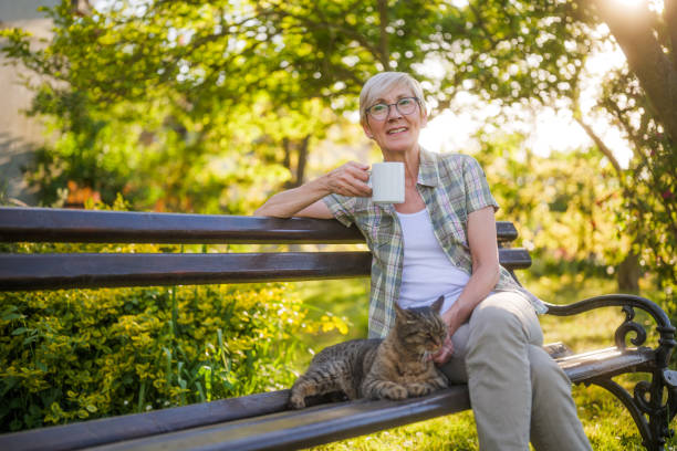 istock Senior woman drinking coffee and spending time with her cat 2152305363