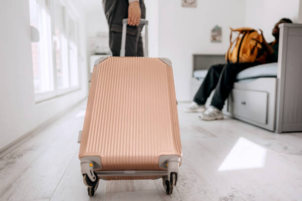 istock Close up shot of woman pulling suitcase while entering hotel room 2152305484