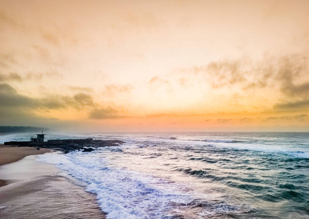 Amanzimtoti beach, south of Durban city in Kwazulu-Natal, showing the tidal pool, a scenic seascape at early sunrise.