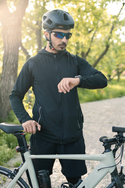 istock man on bike looking at his smartwatch 2152306889