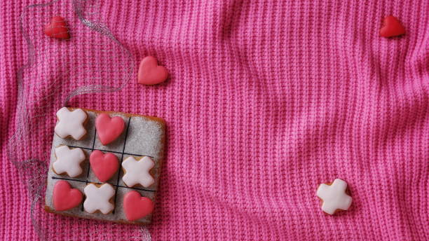 istock Noughts and crosses. Horizontal Banner for Website. Love Conception. Gingerbread on a Pink Sweater Background. Valentines Day Wallpaper 2152308113