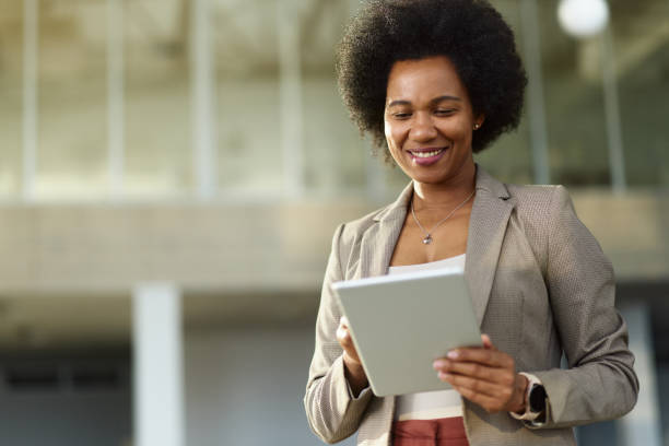 istock Happy black businesswoman working on touchpad in the office. 2152308537