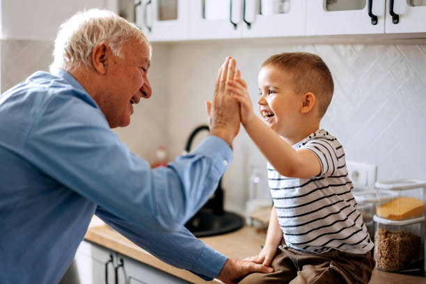 istock Cute little boy having fun with his grandfather in a domestic kitchen 2152308771
