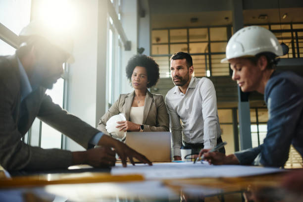 istock Team of architects working on plants at construction site. 2152308895