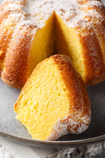 istock Citrus Orange Pound Cake sprinkled with powdered sugar close-up on a plate. Vertical 2152310481