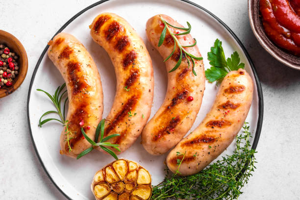 istock Grilled sausages with tomato sauce and herbs 2152311250