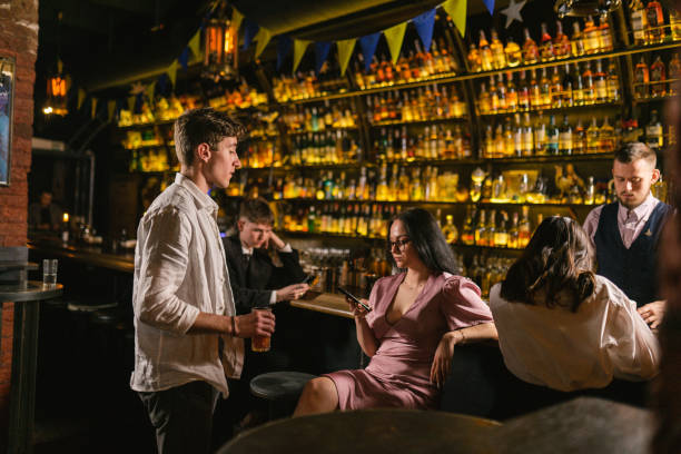 istock Brunette man flirts with disinterested woman in pub 2152313227