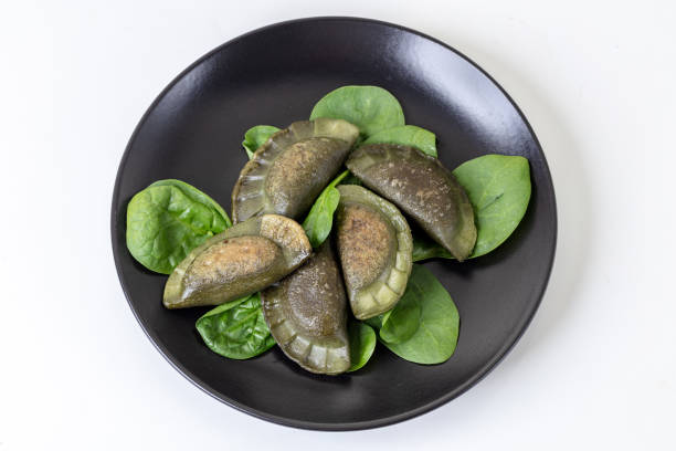 Baked gluten-free spinach dumplings, garnished with spinach leaves