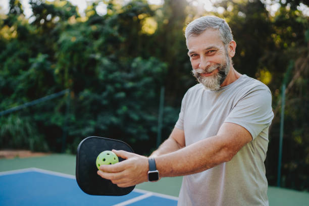 istock Elderly man serving at pickleball 2152316495
