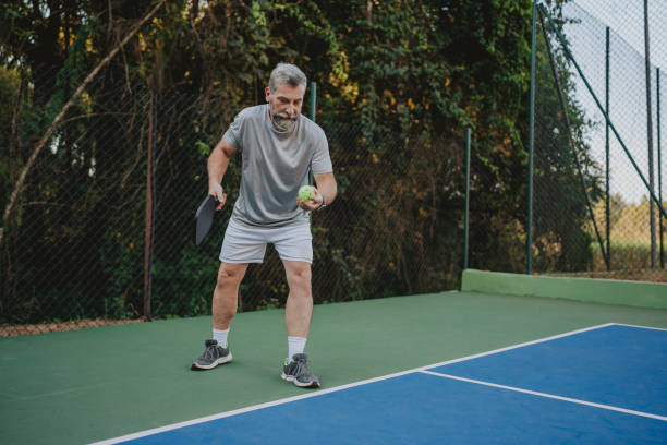 istock Senior man serving in pickleball 2152316611