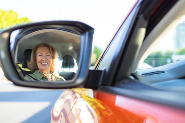 istock Rear-view window - senior woman driving a car 2152317376
